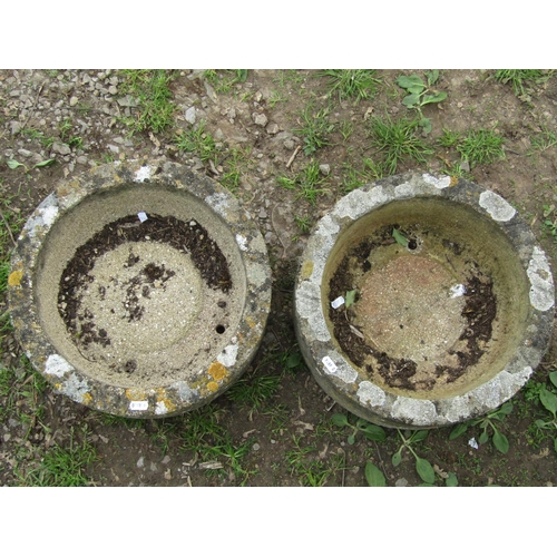 134 - A pair of nicely weathered shallow circular composition stone planters 38 cm in diameter x 14 cm hig... 