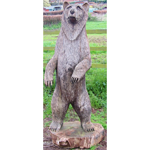 135 - A weathered forest art chainsaw carving of a standing bear with nicely defined features carved from ... 