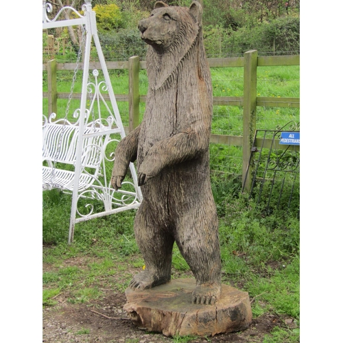 135 - A weathered forest art chainsaw carving of a standing bear with nicely defined features carved from ... 