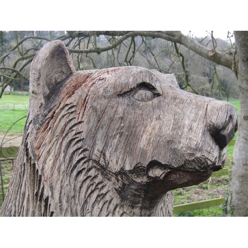 135 - A weathered forest art chainsaw carving of a standing bear with nicely defined features carved from ... 