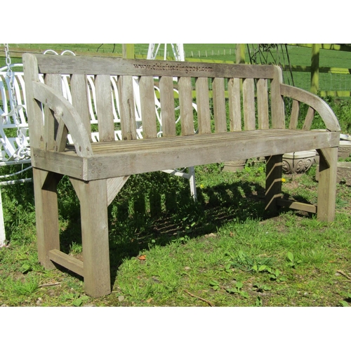 139 - A weathered hardwood garden bench with slatted seat, back and curved arms, (stamped to back rail www... 