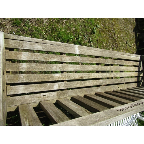 139 - A weathered hardwood garden bench with slatted seat, back and curved arms, (stamped to back rail www... 