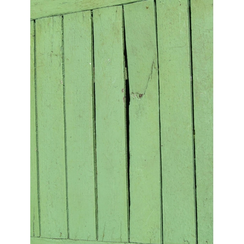 154 - A weathered light green painted rustic garden table, the overhanging rectangular slatted panelled to... 