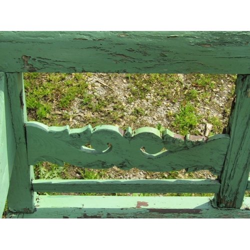 154 - A weathered light green painted rustic garden table, the overhanging rectangular slatted panelled to... 