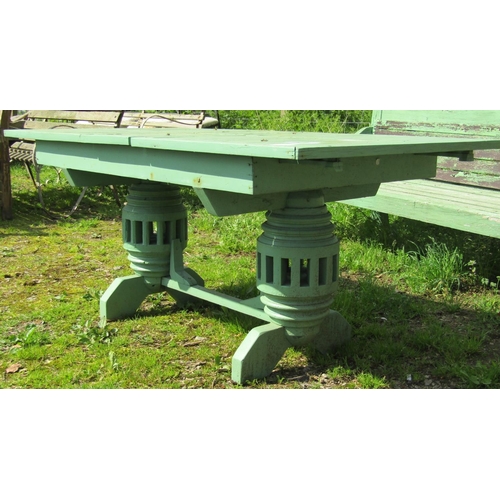 154 - A weathered light green painted rustic garden table, the overhanging rectangular slatted panelled to... 