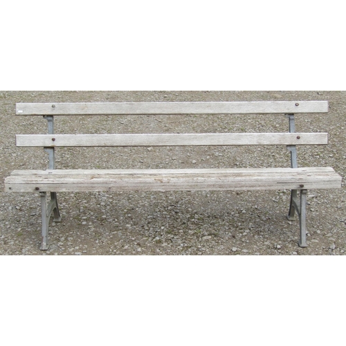 160 - A garden bench with simple weathered slatted wooden seat and back rails raised on cast alloy support... 