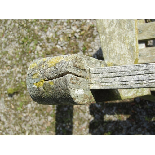 161 - A vintage weathered teak three seat garden bench with slatted seat and back probably a Lister exampl... 