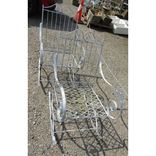 162 - A pair of decorative painted ironwork garden rocking chairs with open scrolled arms and lattice pane... 