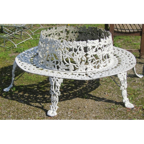 165 - A reproduction cream painted cast iron low tree seat with decorative repeating fruiting grapevine an... 