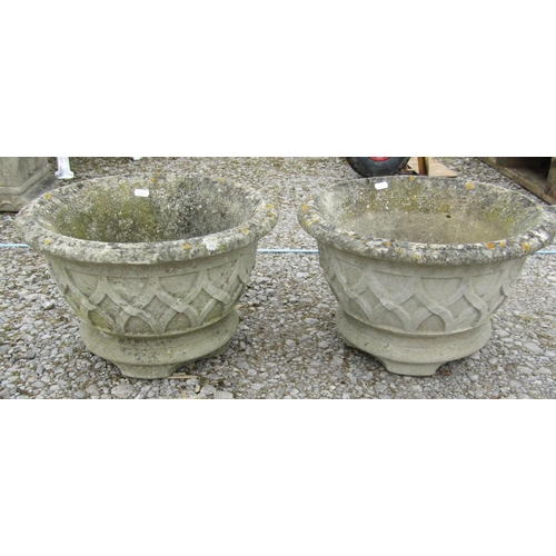 171 - A pair of weathered cast composition stone squat circular tapered garden urns with lattice detail, 4... 