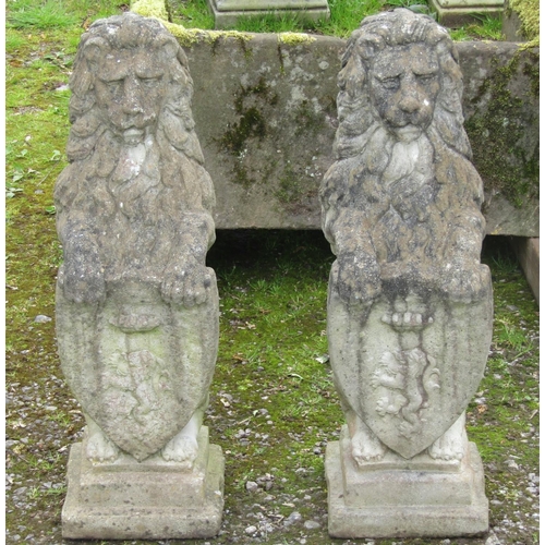 174 - A pair of nicely weathered cast composition stone garden terrace/pier ornaments in the form of lions... 