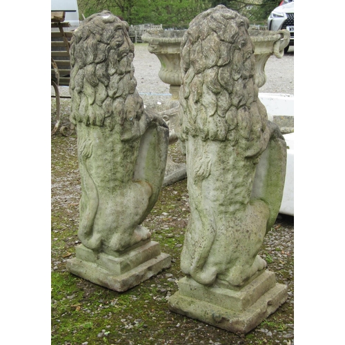 174 - A pair of nicely weathered cast composition stone garden terrace/pier ornaments in the form of lions... 