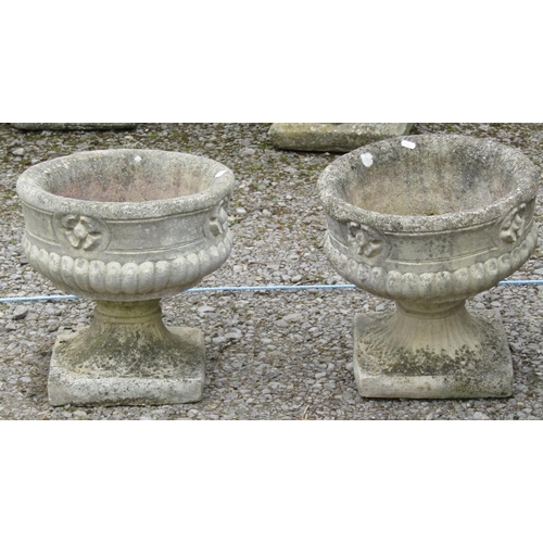 175 - A pair of weathered cast composition stone campana shaped garden urns with decorative classical deta... 