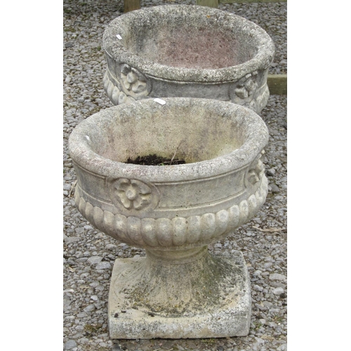 175 - A pair of weathered cast composition stone campana shaped garden urns with decorative classical deta... 