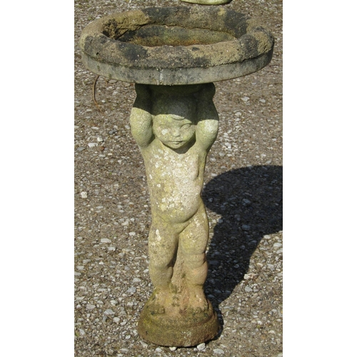 180 - A well weathered cast composition stone two sectional bird bath with circular top raised on a standi... 