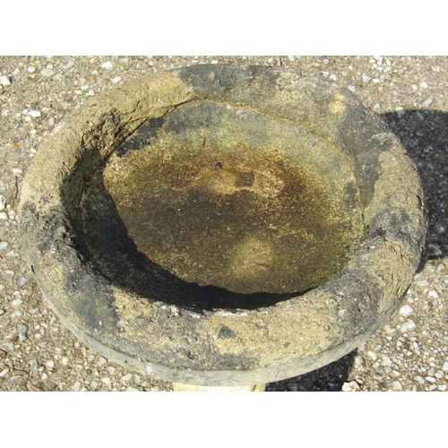 180 - A well weathered cast composition stone two sectional bird bath with circular top raised on a standi... 