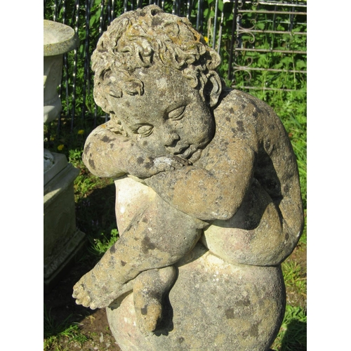 182 - A nicely weathered cast composition stone garden ornament in the form of a sleeping cross legged che... 