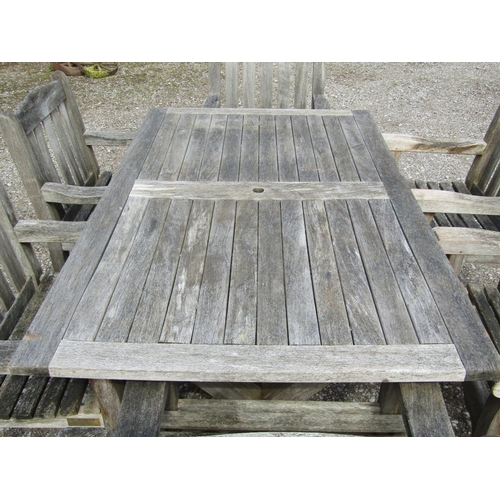 189 - A Woodfurn heavy gauge weathered teak garden table with rectangular overhanging slatted panelled top... 