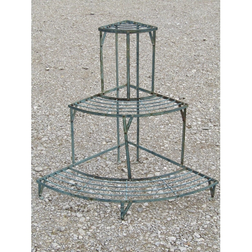 193 - A green painted and weathered light steel floorstanding conservatory/garden corner plant stand on th... 