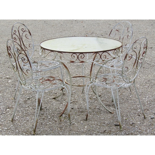 195 - A weathered iron work garden terrace suite comprising circular inset glass top table 92 cm diameter ... 