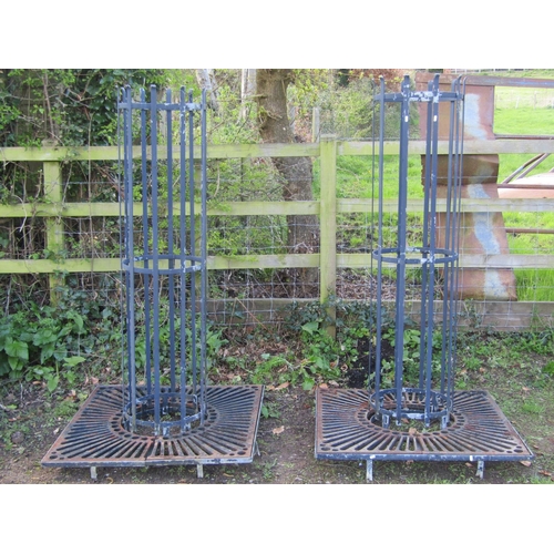 198 - A pair of painted heavy gauge galvanised steel cylindrical strapwork tree guards and square stands w... 