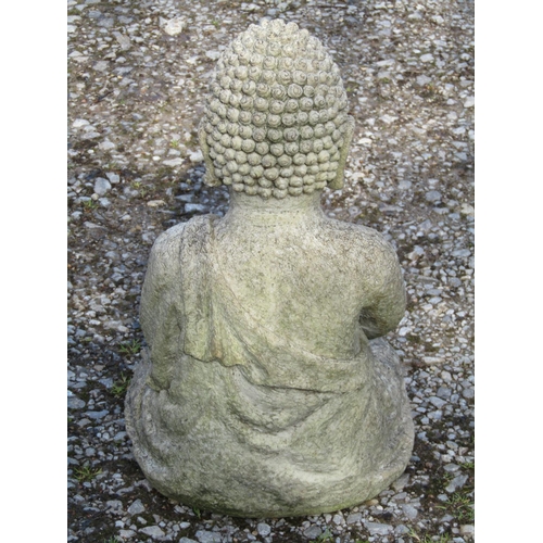 201 - A small moulded fibreglass to simulate stone garden ornament in the form of a seated cross legged bu... 