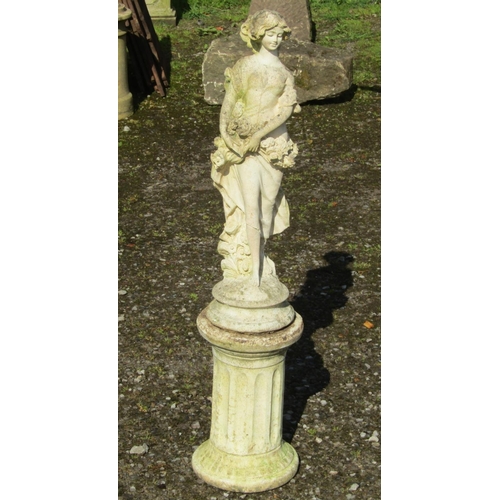 203 - A small cast composition stone garden ornament in the form of a flower maiden raised on a squat cyli... 