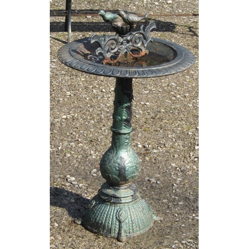 205 - A painted and weathered reproduction cast iron bird bath raised on a vase shaped and flared domed pe... 