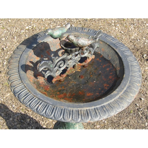 205 - A painted and weathered reproduction cast iron bird bath raised on a vase shaped and flared domed pe... 