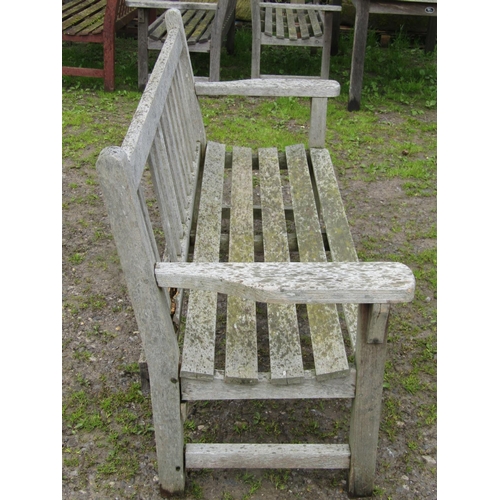 30 - A vintage heavy gauge weathered teak garden bench with slatted seat and back, 162 cm wide together w... 