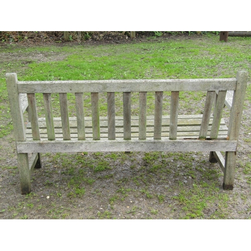 30 - A vintage heavy gauge weathered teak garden bench with slatted seat and back, 162 cm wide together w... 
