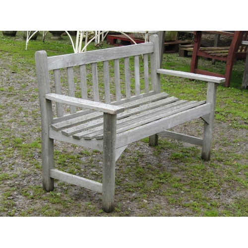 38 - A vintage weathered/silvered teak two seat garden bench with slatted seat and back, probably a Liste... 