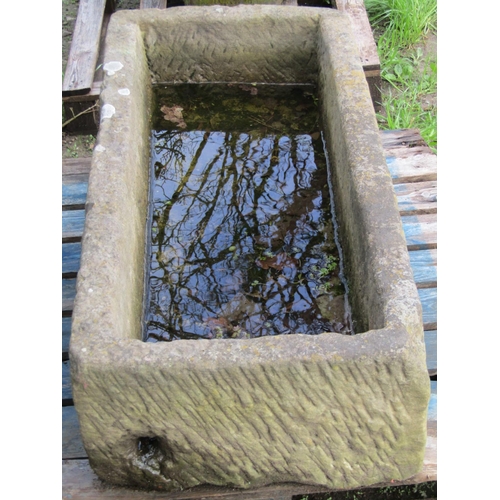 57 - A good weathered thick walled rectangular natural stone trough with corner drainage hole 125 cm long... 