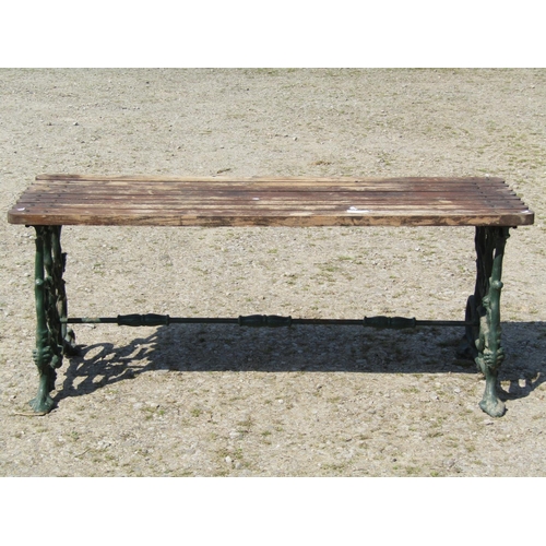 71 - A good quality heavy gauge garden table with rectangular hardwood slatted top raised on scrolling se... 