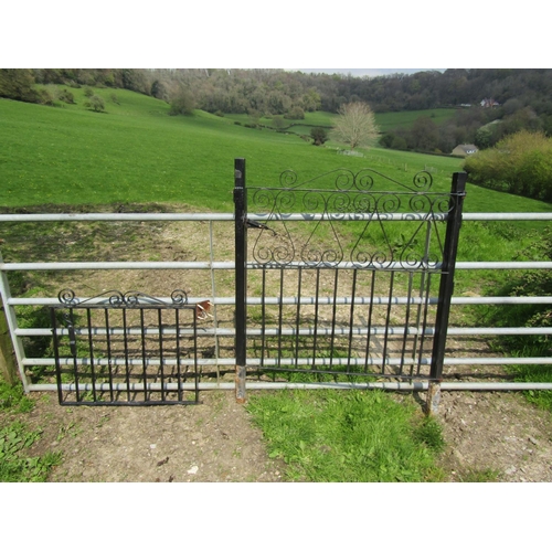 72 - A pair of unusual hinged folding iron work driveway entrance gates with twisted vertical bars and op... 