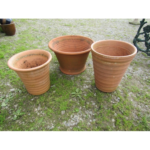 74 - Three terracotta ribbed planters of various size and design, the largest example 47 cm in diameter x... 