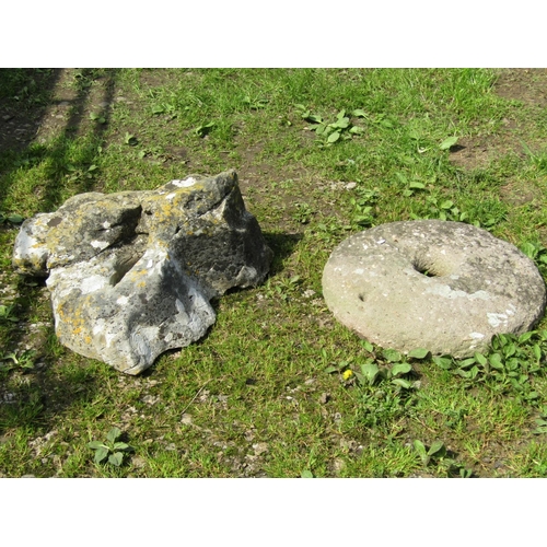 75 - A nicely weathered sculptural rockery stone together with a circular stone cap 54 cm diameter and an... 