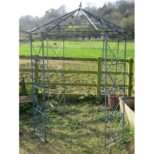 82 - A vintage ironwork gazebo, with four main uprights, supporting an octagonal pointed canopy with simp... 