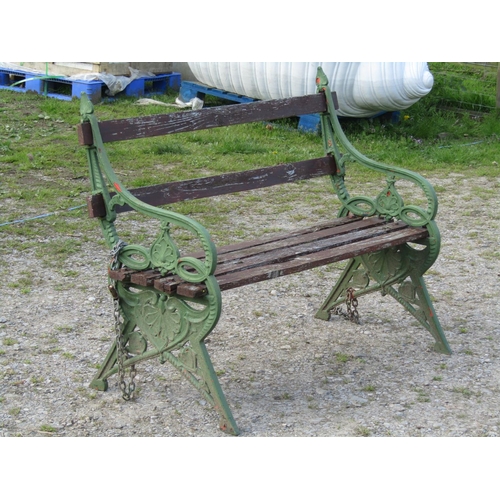 94 - A garden bench with stained wooden lathes, raised on a pair of green painted 19th century bench ends... 