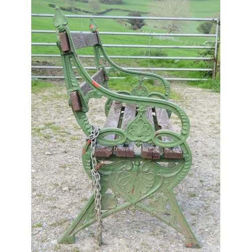 94 - A garden bench with stained wooden lathes, raised on a pair of green painted 19th century bench ends... 