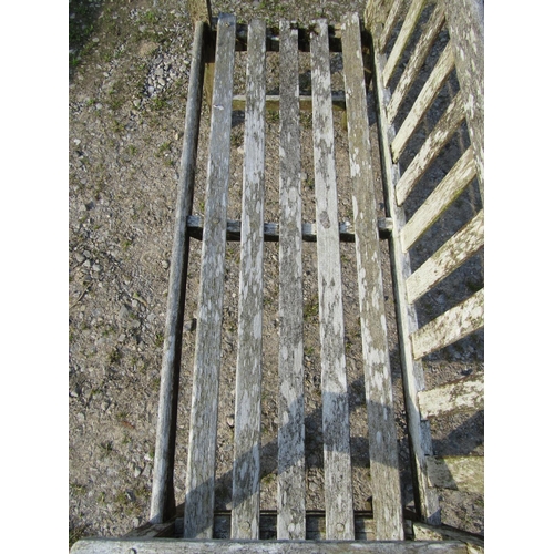 95 - A weathered Gloster teak two seat garden bench with slatted seat and back, 129cm wide, together with... 