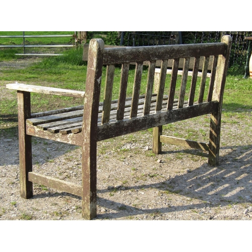 95 - A weathered Gloster teak two seat garden bench with slatted seat and back, 129cm wide, together with... 