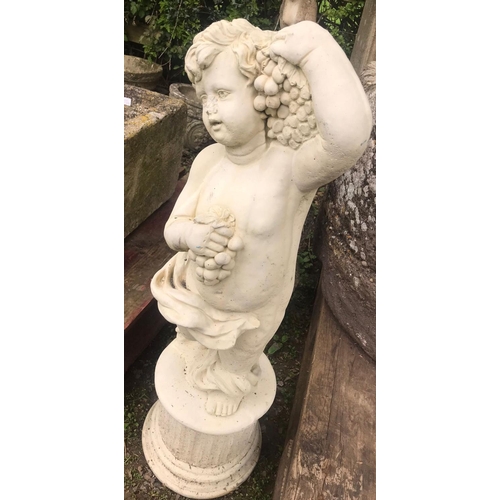 60 - A cast composition stone garden ornament in the form of a standing cherub holding bunches of grapes ... 