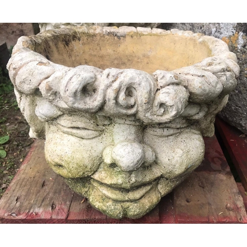 65 - A pair of squat weathered circular composition stone comical head planters, approx 37 cm diameter x ... 