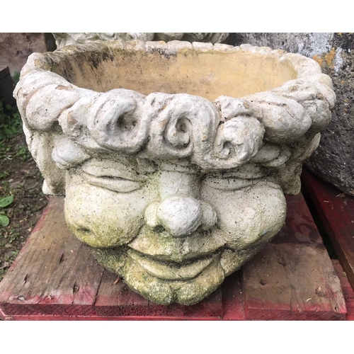 65 - A pair of squat weathered circular composition stone comical head planters, approx 37 cm diameter x ... 