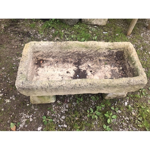 85 - A weathered rectangular reconstituted stone trough, raised on a pair of tapered supports, 93cm long ... 