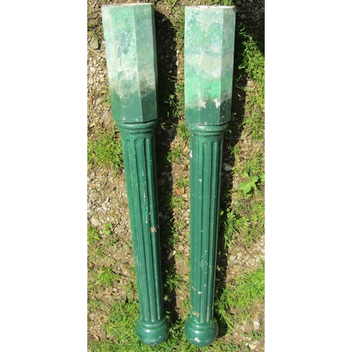 143 - A pair of green painted cast alloy bollards with fluted detail, 130 cm high