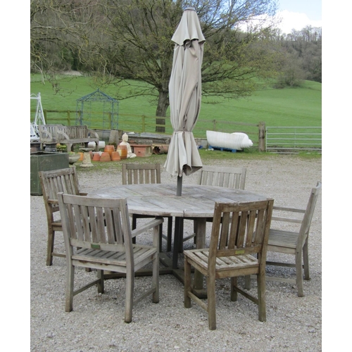 200 - A weathered contemporary hardwood garden table with circular slatted panelled top raised on moulded ... 