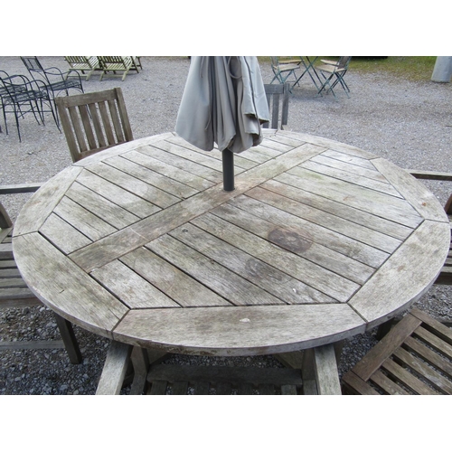 200 - A weathered contemporary hardwood garden table with circular slatted panelled top raised on moulded ... 