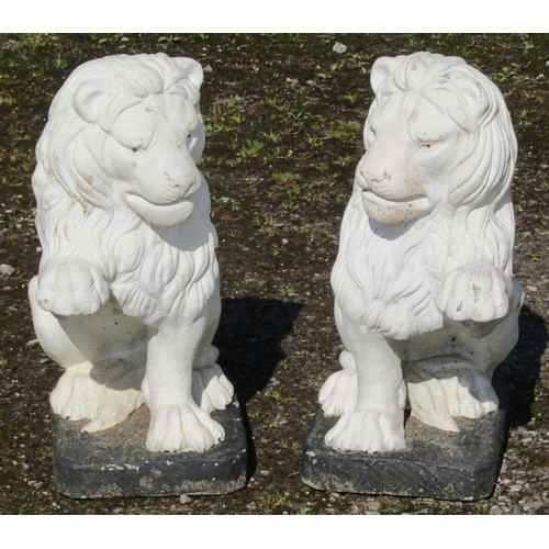 212 - A pair of painted cast composition stone garden ornaments/pier finials in the form of seated lions w... 